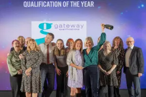 Group of Gateway Qualifications staff on stage at FAB Awards after winning Qualification of the Year