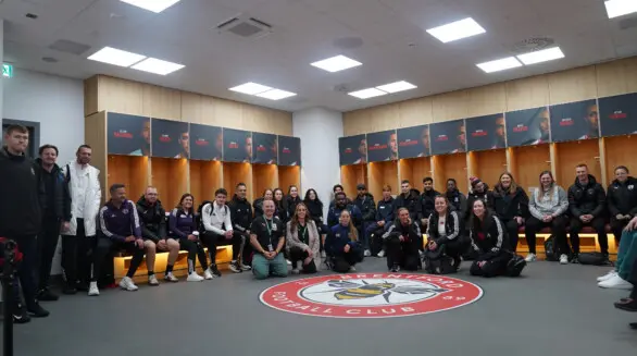 Apprentices wearing the Brentford FC kit photographed in the Brentford FC ground.