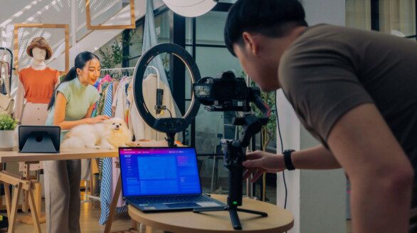 A content creator recording video content using a camera, lighting equipment and digital production tools.