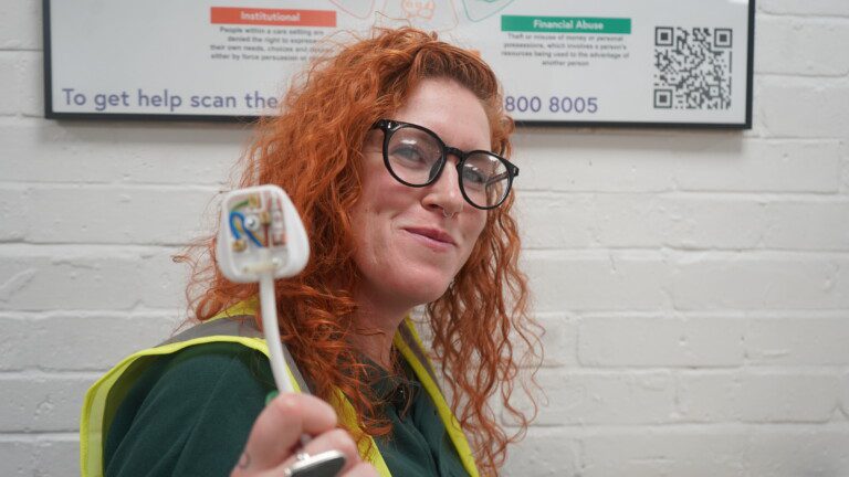 Electrical installation student at Norfolk Council Adult Learning holding a wiring component during practical training towards an electrical qualification.